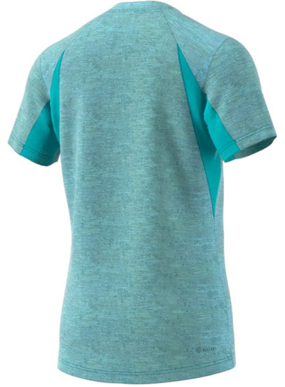 Seen from the back, the ADIDAS Men's Freelift Tennis T-Shirt in a heathered blue showcases darker blue panels and incorporates AEROREADY technology to help keep you cool during intense tennis matches.