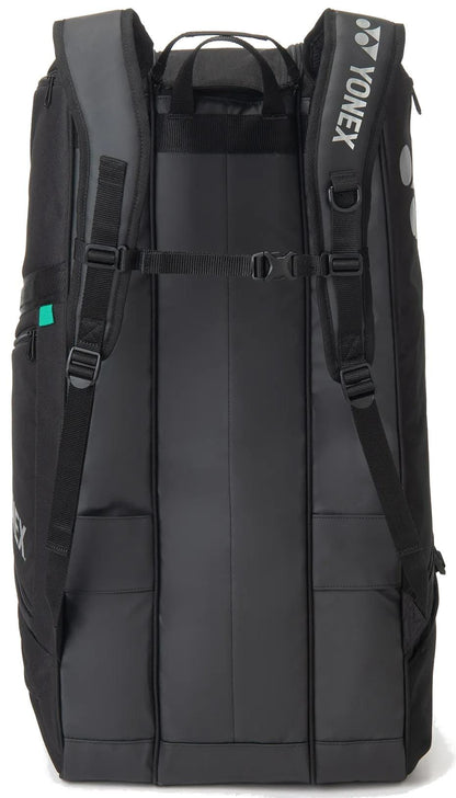 The Yonex BA72629EX Gearlogic 9 Racket Tennis Bag in black features padded shoulder straps, a chest strap, side pockets, and a Yonex logo—offering style and comfort for carrying all your tennis gear.