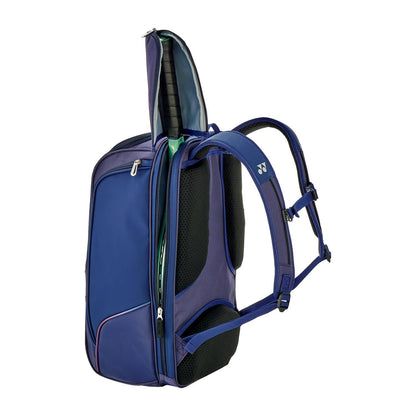 The Yonex 02512EX Expert Tennis Backpack in Navy Blue is designed for serious competitors, featuring multiple compartments, zippers, and padded straps. Easily holds a tennis racket in the top compartment, ideal for expert tournament setups.