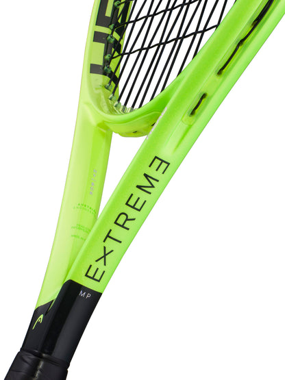 Close-up of the HEAD Extreme MP 2026 Tennis Racket in neon yellow, featuring the "EXTREME" and "MP" markings on the frame; its strings and part of the handle are visible—designed by HEAD for players who want to maximize spin and power in every shot.