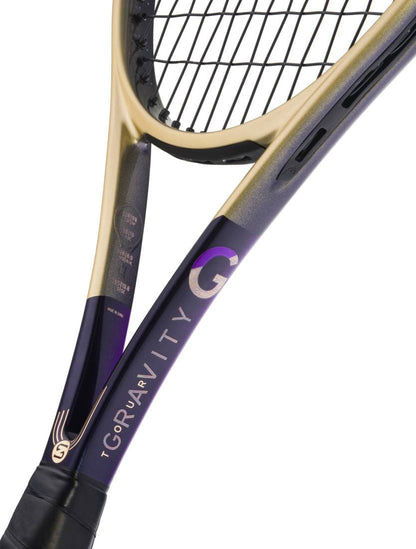 Close-up of the HEAD Gravity Tour Zverev 2026 Tennis Racket—a limited edition from HEAD—showcasing its metallic gold and purple frame with “GRAVITY” and “TOUR” inscribed on the shaft, plus black strings inspired by Alexander Zverev.