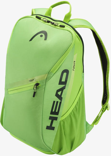 A HEAD Tour 25L Tennis Backpack in Sharp Green is displayed at an angle against a white background, highlighting the HEAD logo and "TOUR" branding in black text. This 25-liter tennis backpack features a zippered front pocket and adjustable shoulder straps.