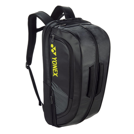 The Yonex 02312EX Expert Backpack by Yonex, in stylish black complemented by yellow branding, provides a contemporary appearance with several compartments and cushioned shoulder straps. Equipped with zippered pockets, this adaptable alternative to a racket bag is perfect for sports or travel.