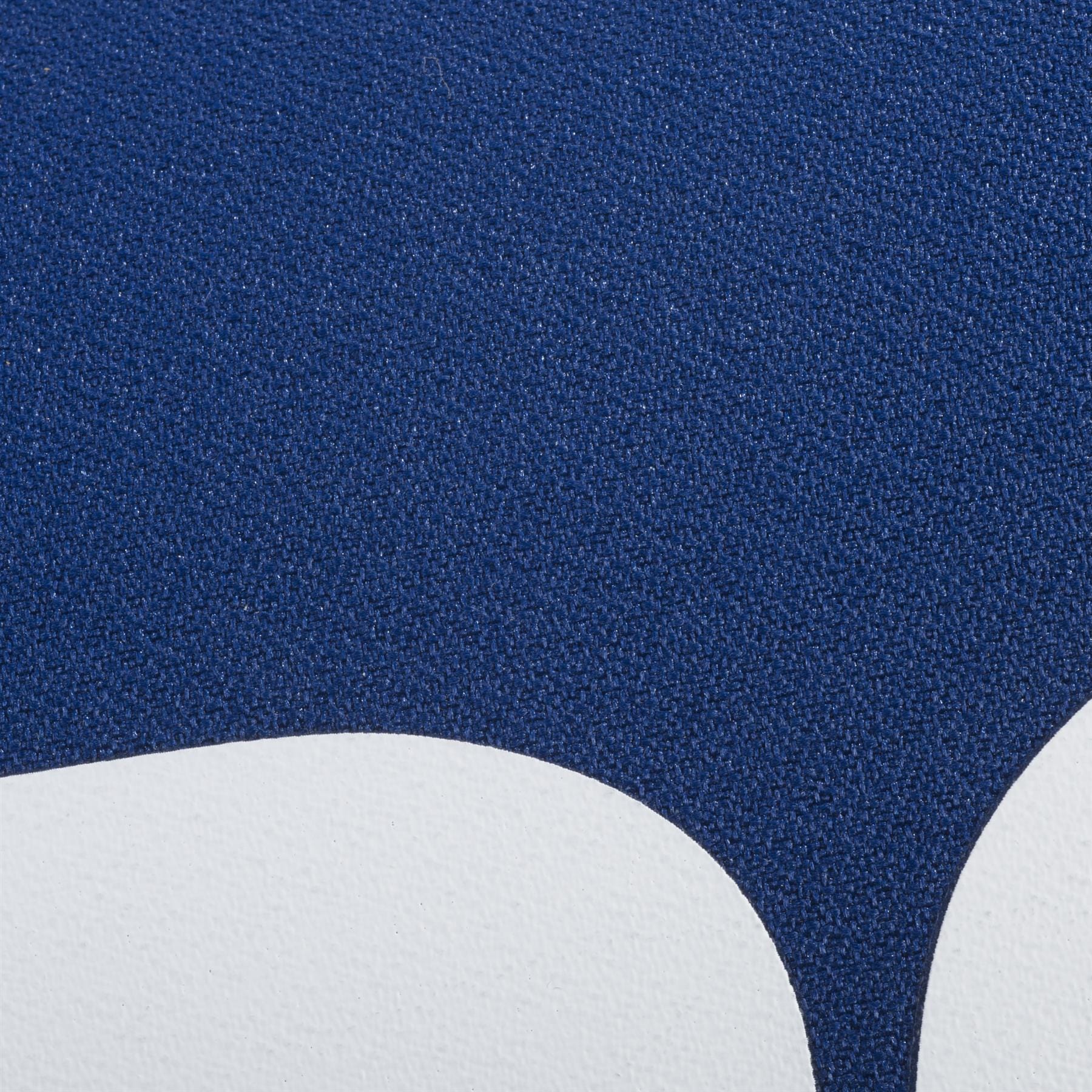 Close-up of a textured surface with a curved white shape below deep blue, inspired by the sleek Babolat Court XS 3 Racket Tennis Bag - Blue—ideal for fans of abstract or minimalist design and the renowned Babolat brand.