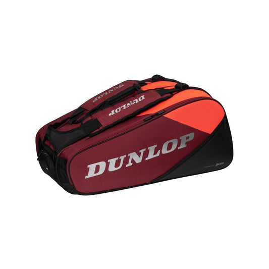 Introducing the Dunlop CX Performance 12 Tennis Racket Bag in Black and Red. This stylish bag prominently displays the Dunlop logo and features various compartments to keep your equipment organized. It includes black ergonomic padded shoulder straps for comfort and a ventilated shoe compartment for added convenience.