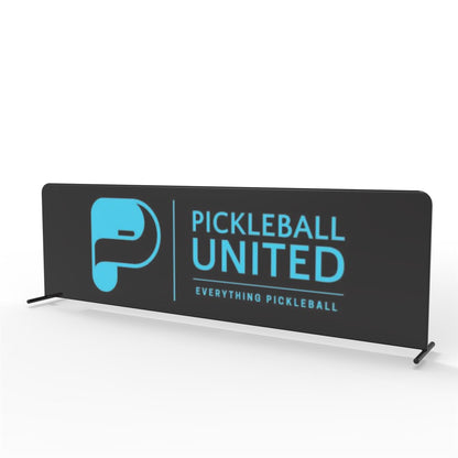 The Pickleball United Court Surround Barriers feature a black design with a steel frame, displaying the Pickleball United logo and “PICKLEBALL UNITED EVERYTHING PICKLEBALL” in light blue on white—perfect for professional spectator events.