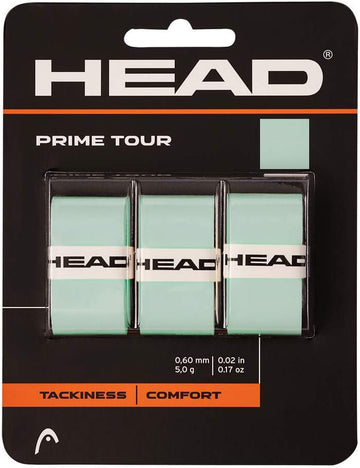 A three-pack of HEAD Prime Tour Tennis Overgrip in Celeste. The black card packaging with orange accents showcases the HEAD logo, lists the 0.60 mm / 0.02 in thickness, and features "Tackiness" and "Comfort" labels—emphasizing the tacky grip that defines HEAD Prime Tour overgrips.
