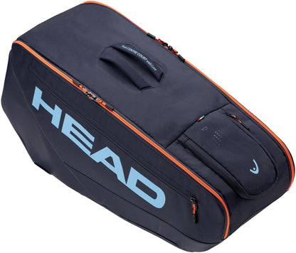 The HEAD Pro 9 Racket Tennis Bag L - Navy features blue HEAD branding, a carrying handle, orange zipper accents, and multiple zippered compartments for climate control and organization.