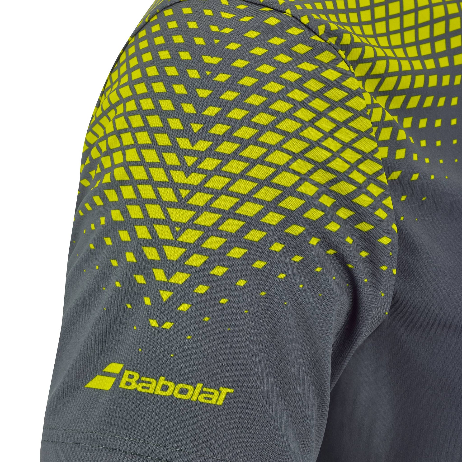 Close-up of the Babolat Aero Crew Neck Men's Tennis T-Shirt in Grey/Aero, featuring a gray sleeve with a yellow geometric pattern and the Babolat logo near the hem—part of Babolat’s performance-driven tennis apparel for men.