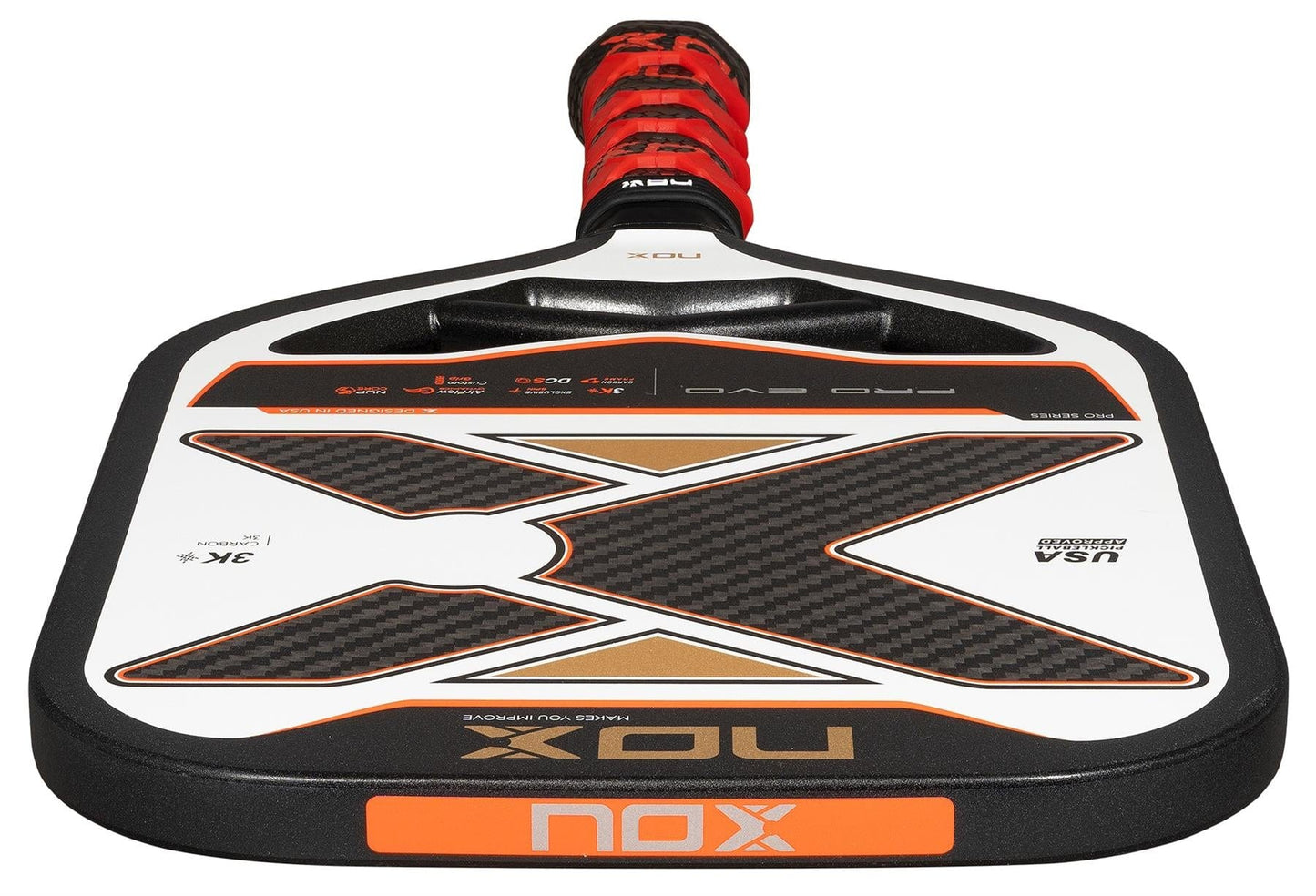 A close-up of the NOX Pro Evo Pickleball Paddle by NOX in black and red, highlighting its large X design on the 3K carbon fiber face and a matching wrapped handle.