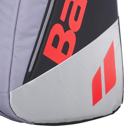 Close-up of the Babolat RH9 Pure Strike 9 Racket Tennis Racket Bag - Carbon Grey by Babolat, featuring a gray, black, and white design with bold red lettering, geometric logos, water-repellent material, and a visible zipper edge.