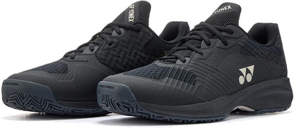 A pair of Yonex Power Cushion Sonicage Men's Tennis Shoes in Black/Mocha Grey, featuring textured rubber soles, mesh panels for breathability, and Yonex logos on the sides and tongue, shown side by side on a white background. Durable and lightweight.
