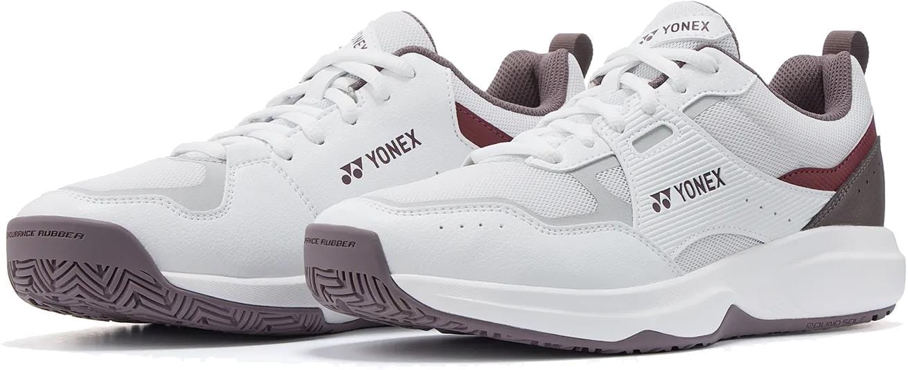 The Yonex Pro-Move Classic WIDE Men's Tennis Shoes in white and red, featuring lace-up design, Power Cushion technology, and textured rubber soles, are displayed against a white background.