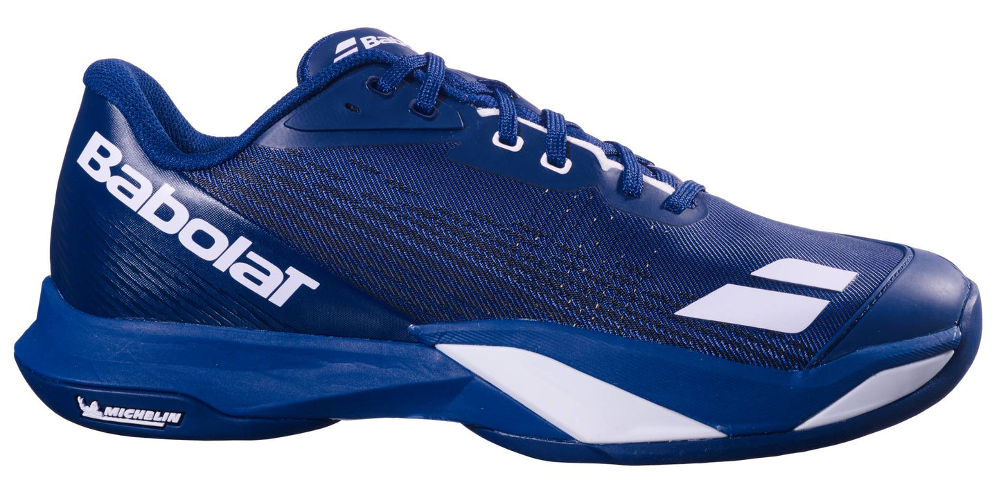 The Babolat Jet Mach 4 All Court Men's Tennis Shoes in dark blue and white feature a white side logo, Michelin sole branding, and a low-profile lace-up design for responsive agility.