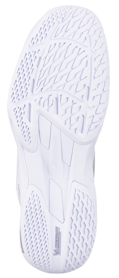 Close-up of the white sole on the Babolat Jet Mach 4 All Court Women's Tennis Shoes in White/Silver, highlighting textured patterns, grooves, and grid-like designs for agility. The Babolat logo appears at the center.