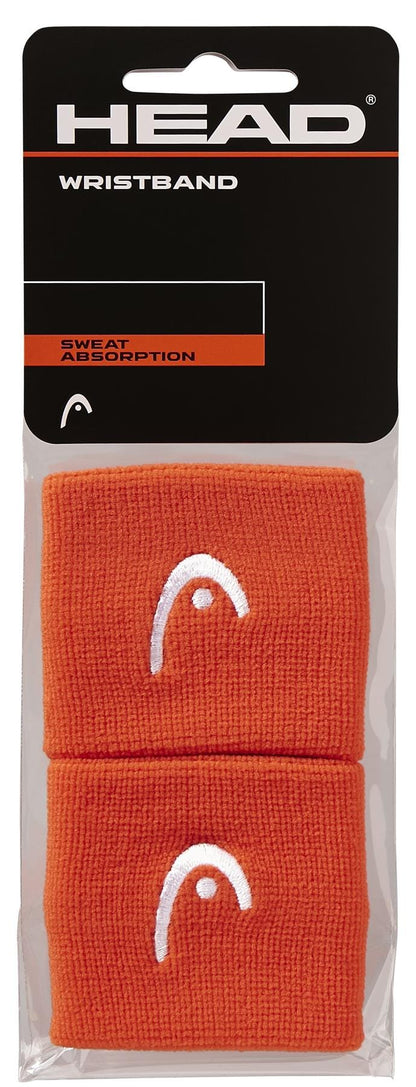 The HEAD 2.5" Tennis Wristband in orange includes two wristbands with a white logo, packed in a clear bag with a black "HEAD WRISTBAND" label highlighting "SWEAT ABSORPTION". Perfect for tennis or as a sweatband.