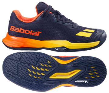 The Babolat Jet Mach 3 Junior All Court Boys Tennis Shoes in Black/Sunset, shown from the side and bottom, feature lightweight design, textured tread, and Michelin branding on the sole.