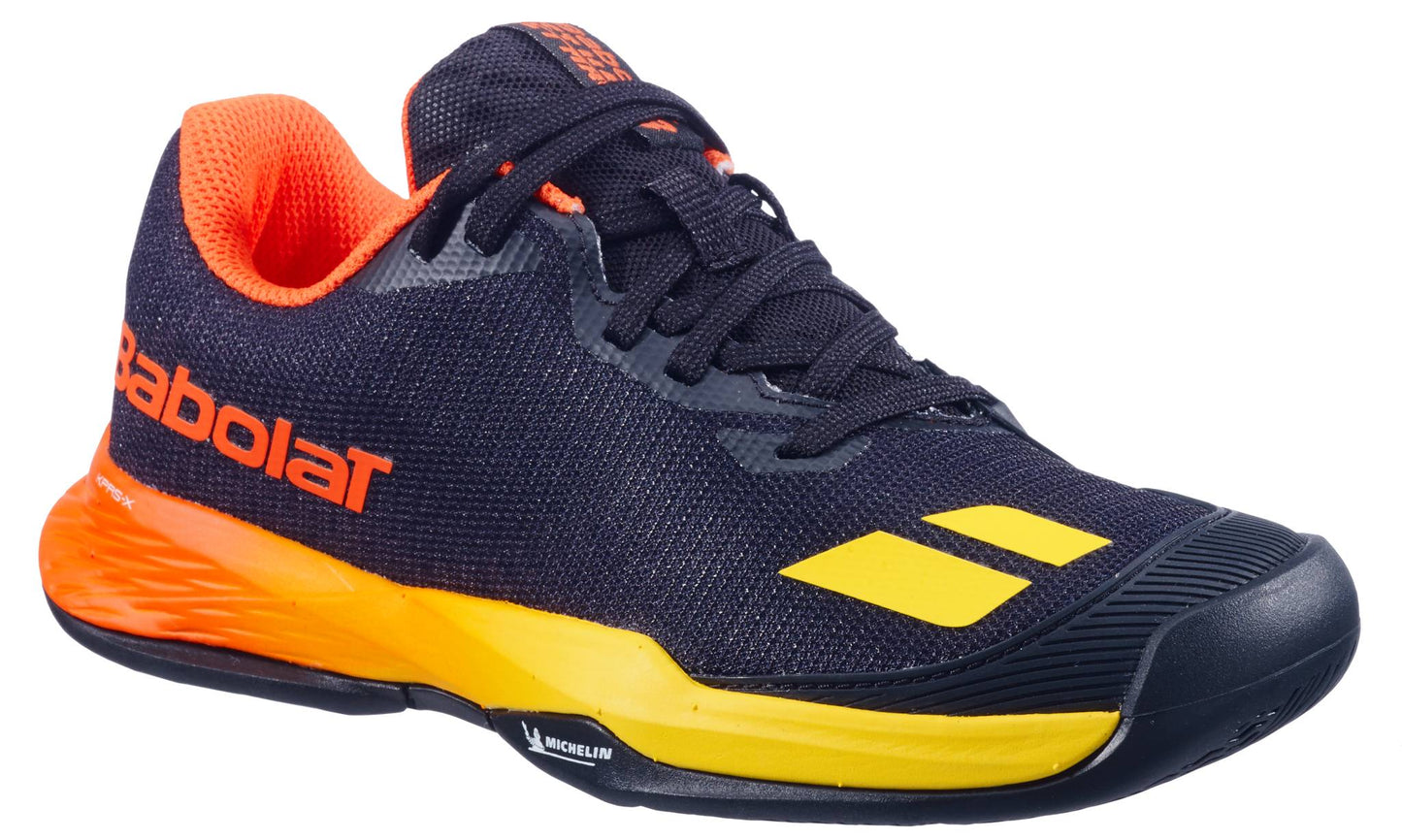 The Babolat Jet Mach 3 Junior All Court Boys Tennis Shoes in Black/Sunset are lightweight, feature black and yellow colors with orange accents, black laces, and a sturdy rubber sole—ideal for sports performance.