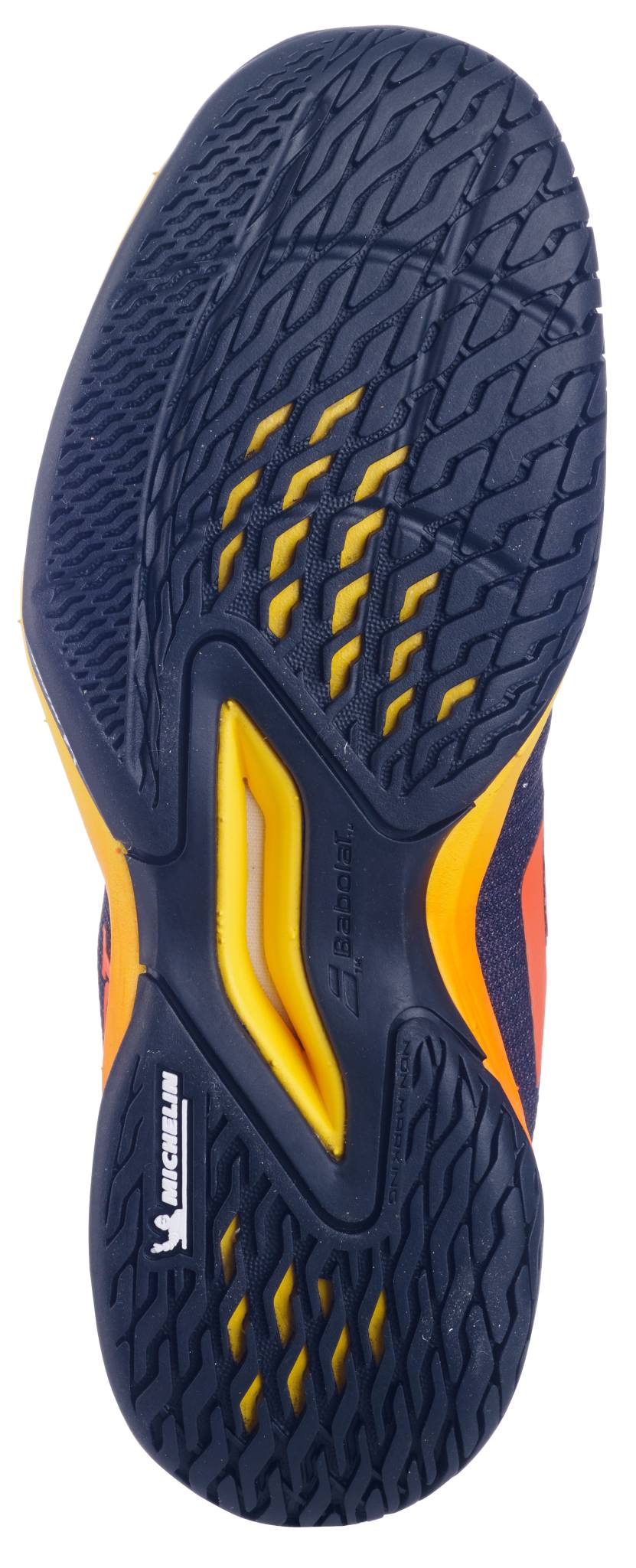 Close-up of the Babolat Jet Mach 3 Junior All Court Boys Tennis Shoe sole in Black/Sunset, showcasing a textured tread with dark blue, yellow, and orange accents. The Michelin logo highlights its lightweight, collaborative design for juniors.