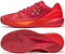 The Yonex Power Cushion Eclipsion 5 Men's Tennis Shoes in Ruby Red are shown from the side and bottom, featuring a herringbone sole, geometric upper design, and a Yonex logo with two circles and a triangle on the side.