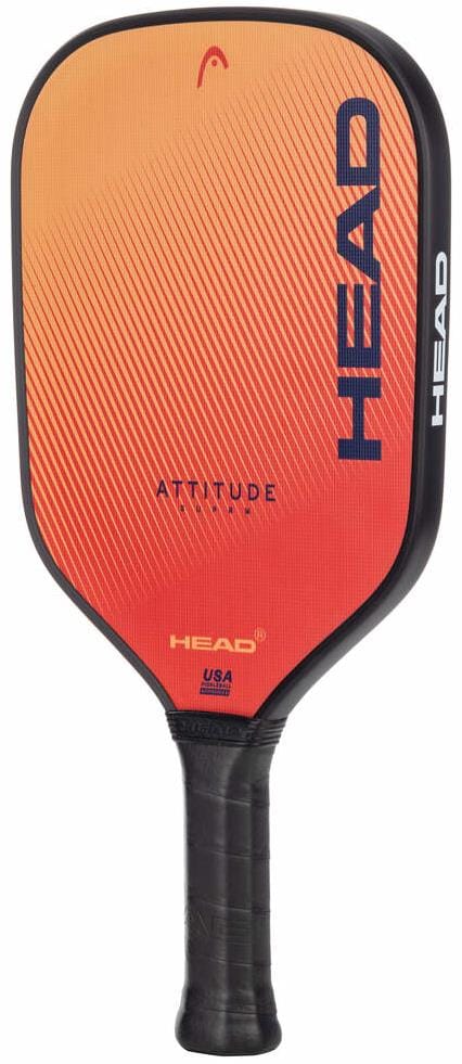 The HEAD Attitude SUPRM Pickleball Paddle features an orange-red gradient face with “ATTITUDE” at the center and bold blue “HEAD” along the side. Its black wrapped handle provides great spin control, perfect for new players.