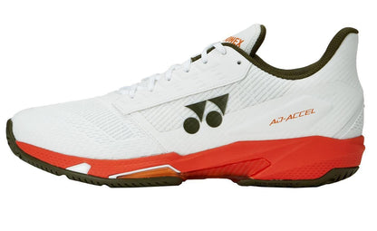 The Yonex Power Cushion Ad-Accel Men's Tennis Shoes by Yonex feature a white upper with black and orange accents, a textured surface, "AD-ACCEL" text on the side, and an orange sole designed for quick court movement.