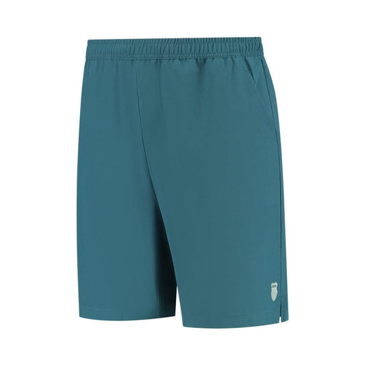 Introducing the K-Swiss Hypercourt Men's 7 Inch Tennis Shorts in Indian Teal, featuring an elastic waistband for a comfortable fit. These shorts have a small white logo on the lower left side and are crafted from lightweight fabric with 4-way density stretch, ensuring ease of movement for both sports and casual activities. Practical deep side pockets enhance the versatility of these stylish athletic shorts.