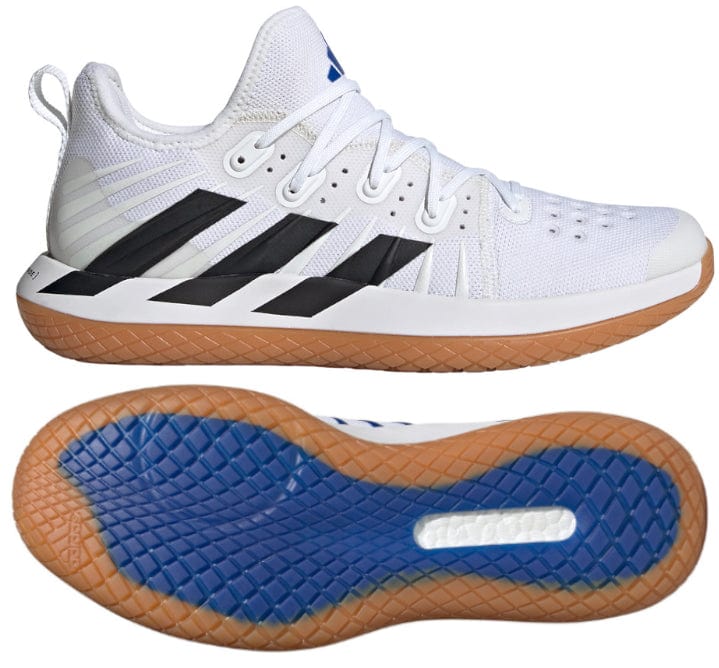 The ADIDAS Stabil Next Gen Primeblue men's indoor shoes, branded as adidas, are designed in Cloud White with Core Black accents. They feature a gum sole and showcase a sleek side profile with perforations for breathability, while the sole displays a blue tread pattern for superior traction and energy return, perfect for indoor court use.