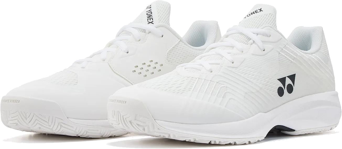 The Yonex Power Cushion Sonicage Wide Unisex Tennis Shoes in white feature mesh panels for breathability, laces, and the Yonex logo on the side. These lightweight shoes are shown on a white background.