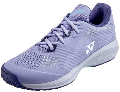 The Yonex Power Cushion Sonicage 2025 Clay Women's Tennis Shoes in Mist Purple feature a lightweight design, white accents, mesh panels, textured shock-absorbing sole, Yonex side logo, laces, and a cushioned collar for support.