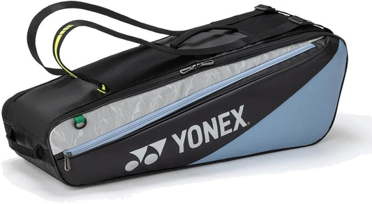 The Yonex BA52526EX Club 6 Racket Tennis Bag in black and blue features the Yonex logo and two zippered compartments—an ideal, durable choice for athletes needing organized storage for up to six rackets or sports gear.