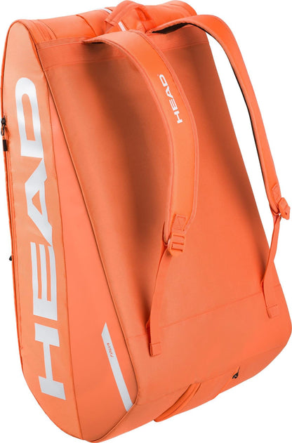 The HEAD Tour 12 Racket Tennis Bag XL - Orange features white branding, two backpack-style shoulder straps, a side zipper pocket, spacious storage for gear, and climate control technology to protect your equipment.