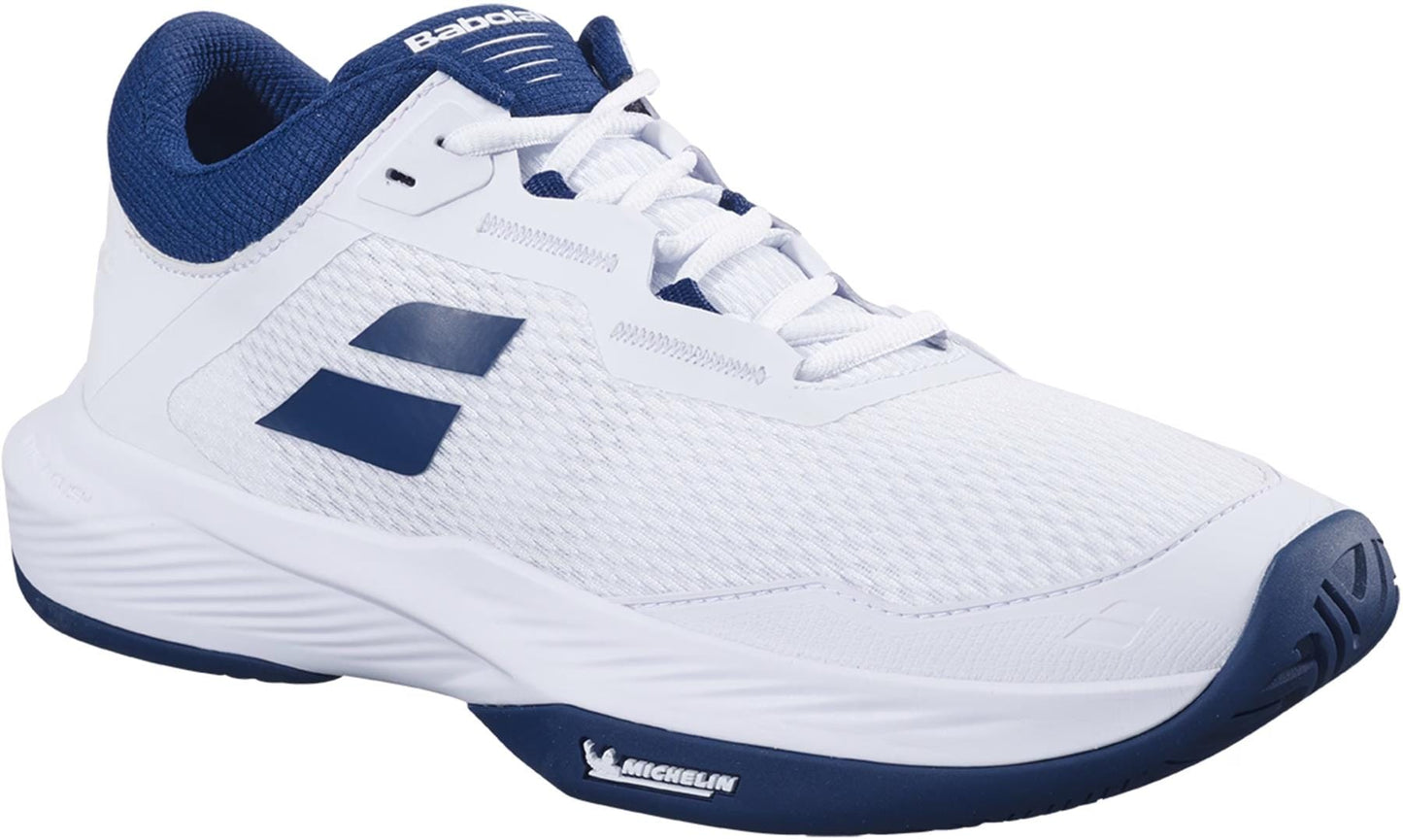 The Babolat SFX 4 All Court Mens Tennis Shoes in White/Estate Blue feature a mesh upper, navy and dark blue accents, and "Babolat" and "Michelin" logos on the tongue and side, emphasizing comfort for tennis players.