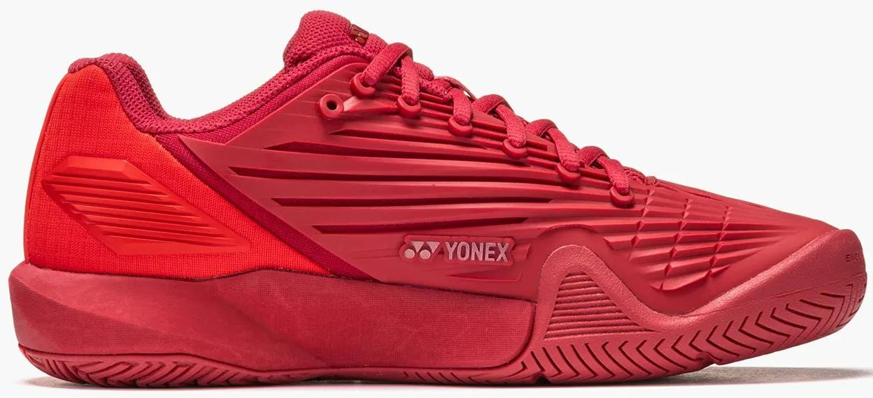 The Yonex Power Cushion Eclipsion 5 Womens Tennis Shoes in Ruby Red feature a textured sole, side panel grooves, mesh heel fabric, and Yonex cushioning—ideal for tennis or sports training.