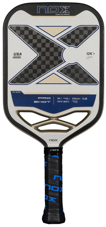 The NOX Pro Shot Pickleball Paddle features a large black and gray X design with blue accents, carbon fibre construction for durability and enhanced spin, and a black and blue grip tape handle. Brand name “NOX” displayed at the top.