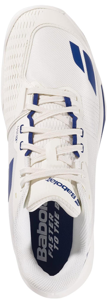 Top view of the Babolat Jet Mach 4 All Court Men's Tennis Shoe in cream and dark blue, featuring white laces, a textured toe, and "Babolat Faster to the ball" on the insole—designed for agility on court.