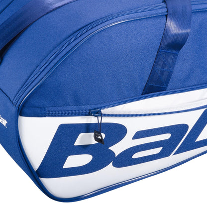 Close-up of the Babolat Court M 6 Racket Tennis Bag in dark blue, featuring a visible zipper and part of the large blue "Babolat" branding on the side.