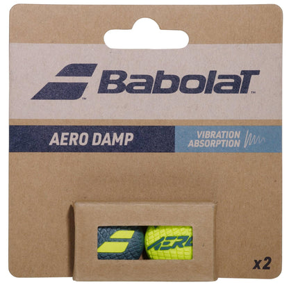 Brown cardboard packaging for the Babolat Aero Damp X2 2026 Tennis Dampener by Babolat, with two visible dampeners—one blue, one yellow—and text "Aero Damp" and "Vibration Absorption" for Pure Aero tennis racket users.