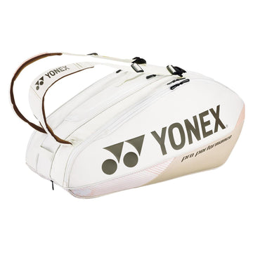 The Yonex 92429EX 9 Racket Pro Tennis Bag in Sand Beige features brown straps and prominently displays the Yonex logo along with the "Pro Performance" text. This bag is equipped with multiple zippered compartments and specialized racket sections featuring Thermo Guard technology to ensure optimal protection for your badminton gear.