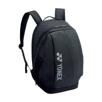 Introducing the Yonex 92412MEX Pro Tennis Backpack in a sleek black design, ideal for athletes on the move. It boasts a curved top with adjustable shoulder straps and offers a spacious main compartment perfect for storing rackets, along with a convenient front zippered pocket. The Yonex logo is prominently displayed on the side for an added touch of style.