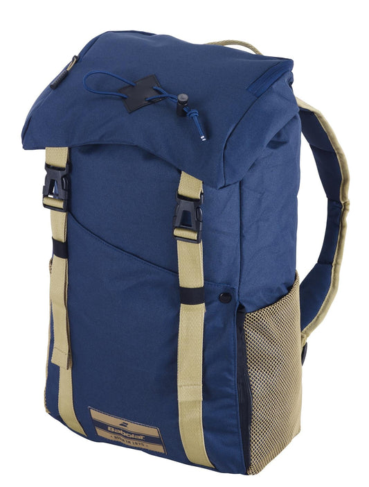 The Babolat Classic Backpack - Dark Blue offers adjustable shoulder straps, a top flap with black buckles, and side mesh pockets. Crafted from recycled PET, this backpack is equipped with a front logo patch and a zipper for extra storage space, making it ideal for transporting your tennis essentials.