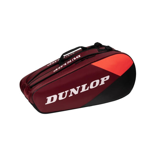 A Dunlop CX Club 10 Tennis Racket Bag in black and red, showcasing the brand's white logo, is displayed against a plain white background. This roomy bag features multiple compartments, including a zippered top section and durable carry handles.