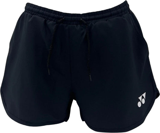 The Yonex YST2024 Womens Tennis Shorts in black feature an elastic waistband, black drawstrings, a small white Yonex logo, and quick-drying material—ideal for active wear with a sporty, minimalist design.