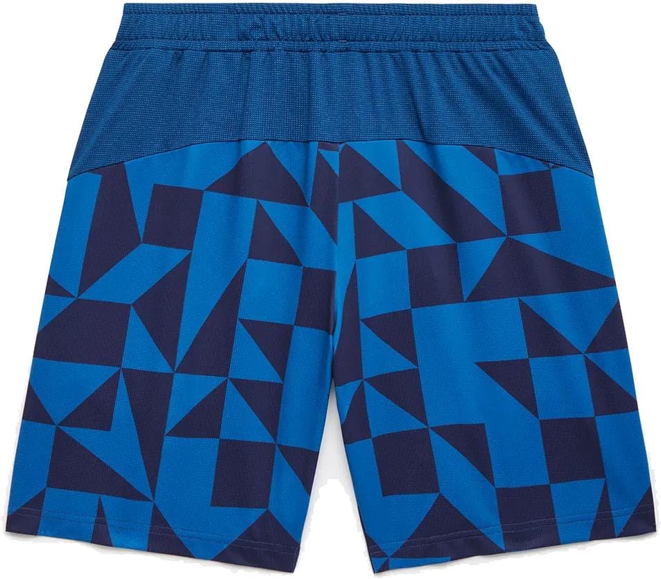 The Yonex 15240YX Knit Men's Tennis Shorts in Indigo Blue feature a geometric triangle and trapezoid pattern, an elastic waistband, solid navy top and waistband, and are made from breathable knit fabric.