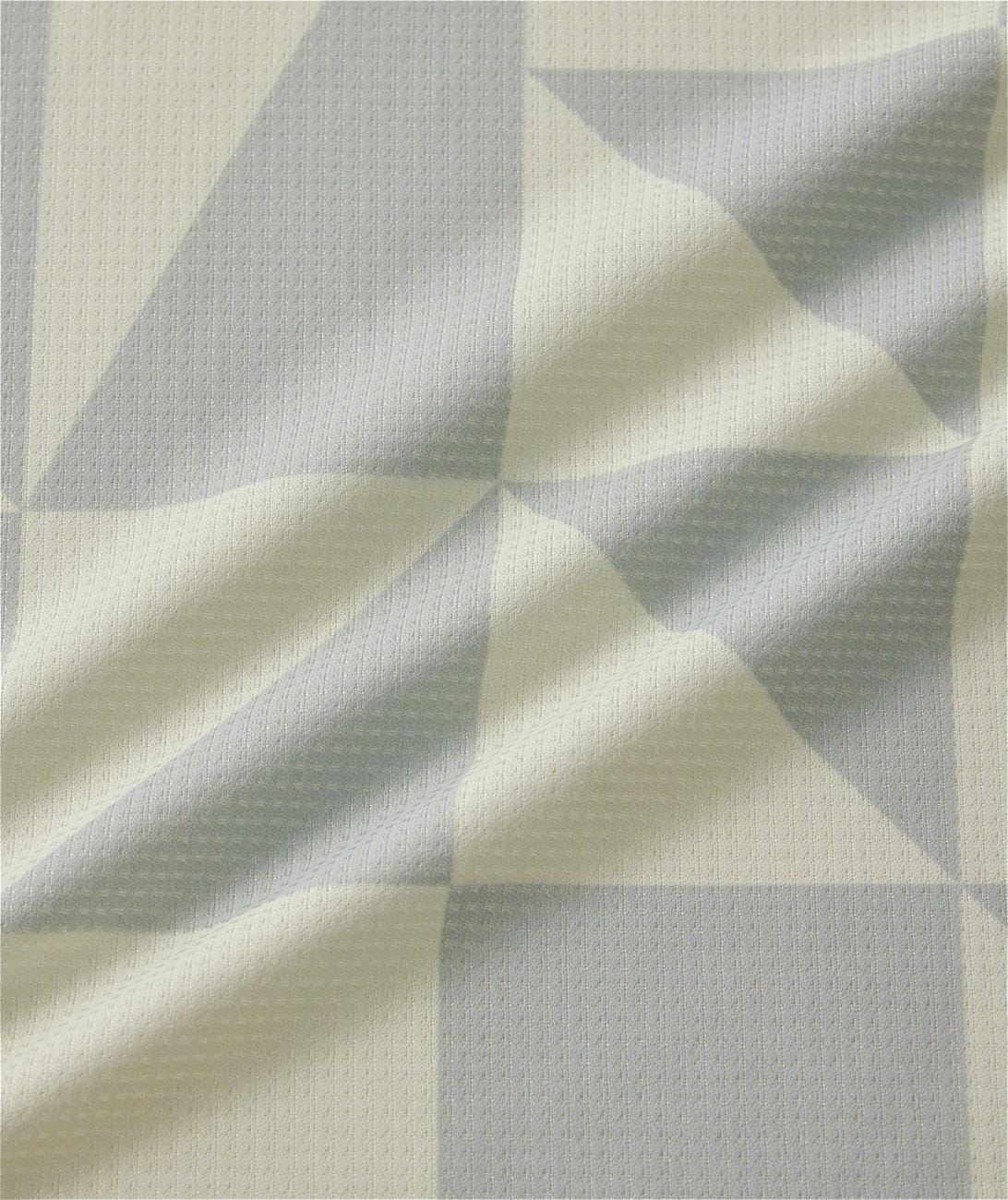 Close-up of light gray and off-white geometric patterned fabric on the Yonex 10712YX Crew Neck Men's Tennis T-Shirt in Champagne, showing its textured surface and soft folds—perfect for sports performance.
