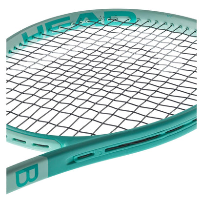 A close-up of a mint-colored HEAD Boom MP 2024 Alternate Tennis Racket highlights the strings and part of the frame. The "HEAD" brand name is prominently displayed on the side, emphasizing its Graphene Inside technology for improved performance. With an innovative design featuring contrasting white text, it incorporates Auxetic 2.0 technology for modern sophistication.