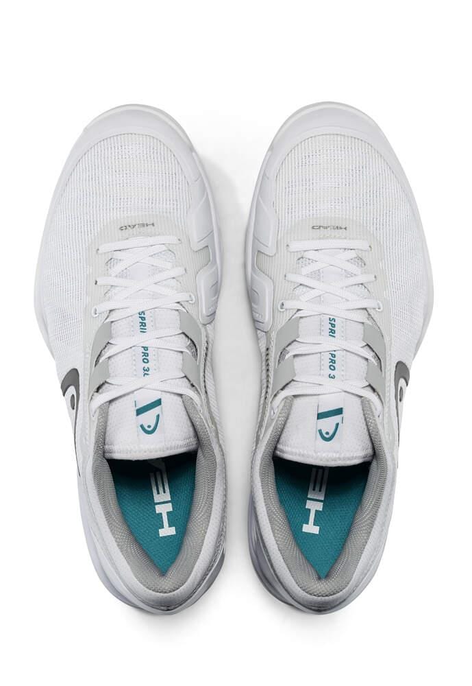 Viewed from above, this pair of HEAD Sprint Pro 3.0 Men's Grass Court Tennis Shoes showcases a white design with grey accents. Featuring a teal insole emblazoned with the HEAD logo, these shoes provide added stability for an optimal fit with their Delta Straps. The tongues display text that includes the shoe size and model information.