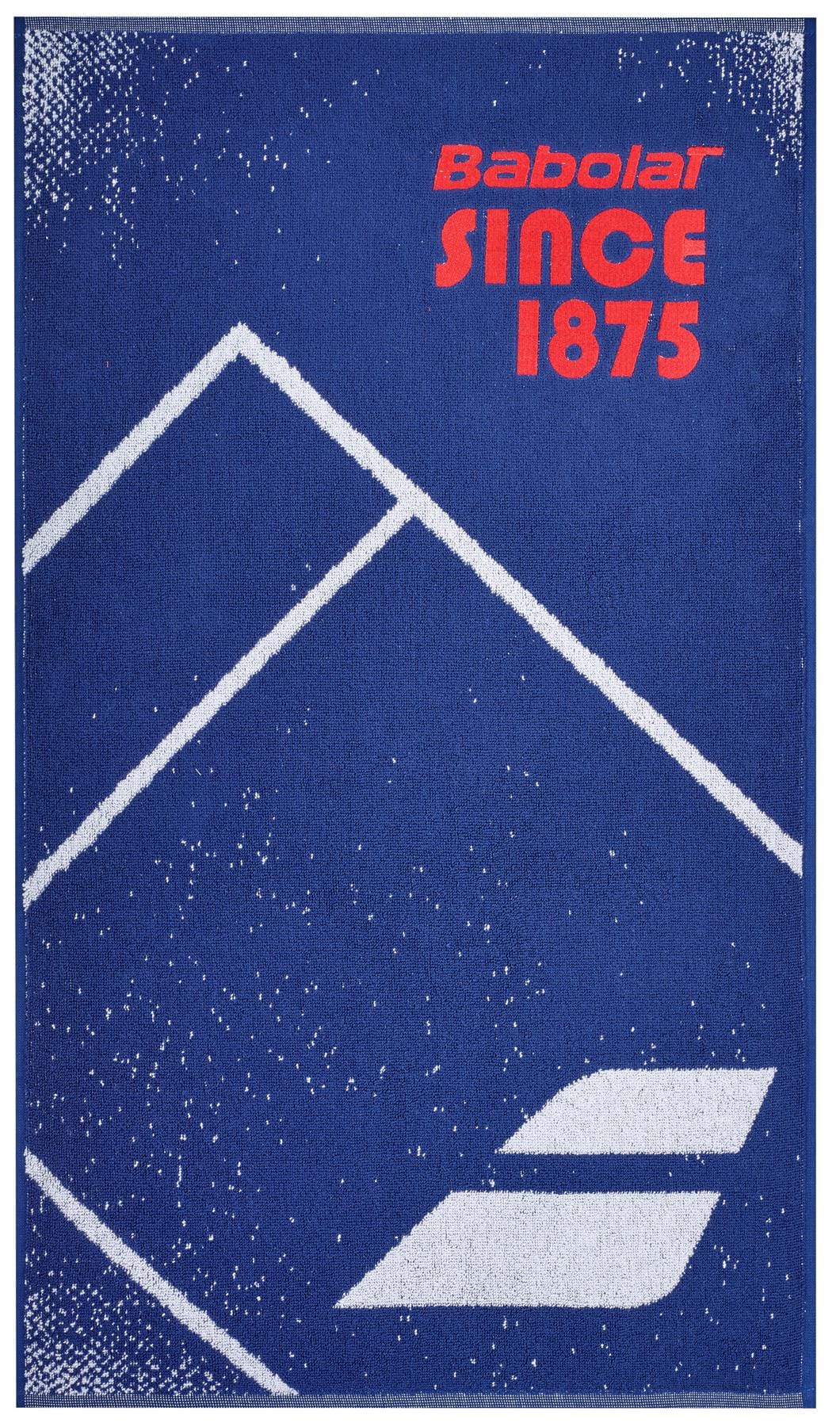 The Babolat Medium Towel - Sodalite Blue, made from 100% cotton, features a vibrant blue background with white geometric mountain shapes and a speckled design. Bold red text at the top proudly displays "Babolat SINCE 1875," while the iconic logo of two diagonal lines is elegantly placed at the bottom, making it an ideal court towel.