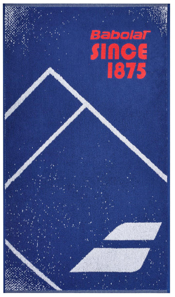 The Babolat Medium Towel - Sodalite Blue, made from 100% cotton, features a vibrant blue background with white geometric mountain shapes and a speckled design. Bold red text at the top proudly displays "Babolat SINCE 1875," while the iconic logo of two diagonal lines is elegantly placed at the bottom, making it an ideal court towel.