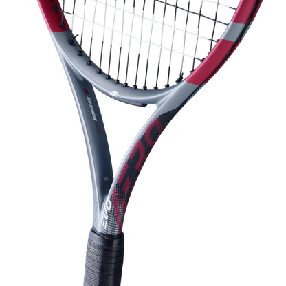 Close-up of the Babolat Evo Aero Pink 2026 Tennis Racket, designed for intermediate to advanced players. It features a sleek pink frame, black grip and strings, visible Babolat branding, and textured details on the throat and handle.